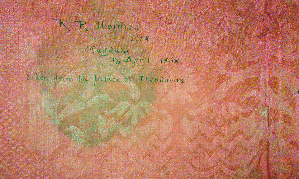 Оборотная сторона Kwer'ata Re'esu покрыта красным шелковым дамаском, который эксперт по текстилю определил как итальянский около 1600 года выпуска. На нем рукой Холмса написано: «взято из дворца Теодоруса». Фото:  Martin Bailey/The Art Newspaper